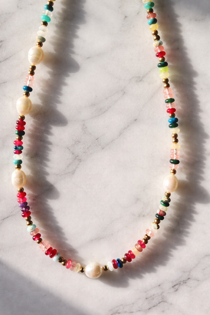 Colorful beaded necklace on a marble surface
