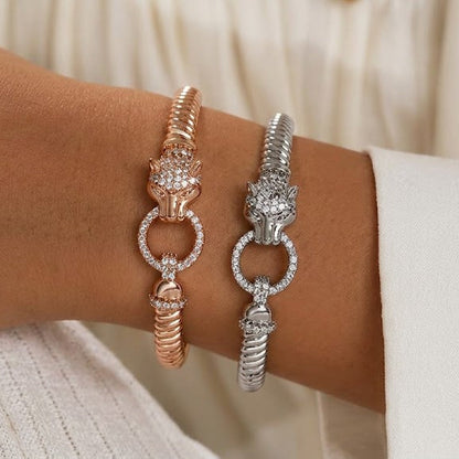 Panther bangle bracelets in gold and silver worn on wrist side by side