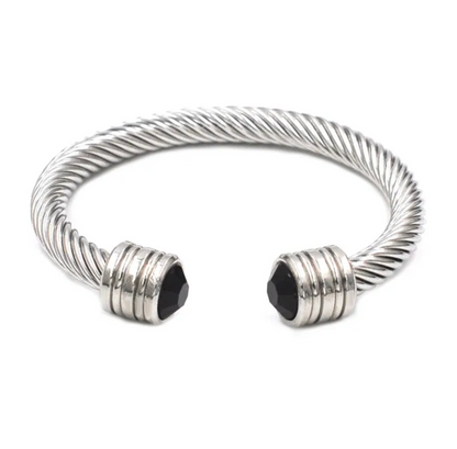 Silver cable-style bracelet with black accents on a white background