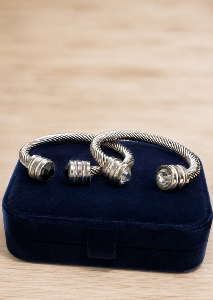 Silver bracelet on a blue velvet jewelry box with a wooden surface background