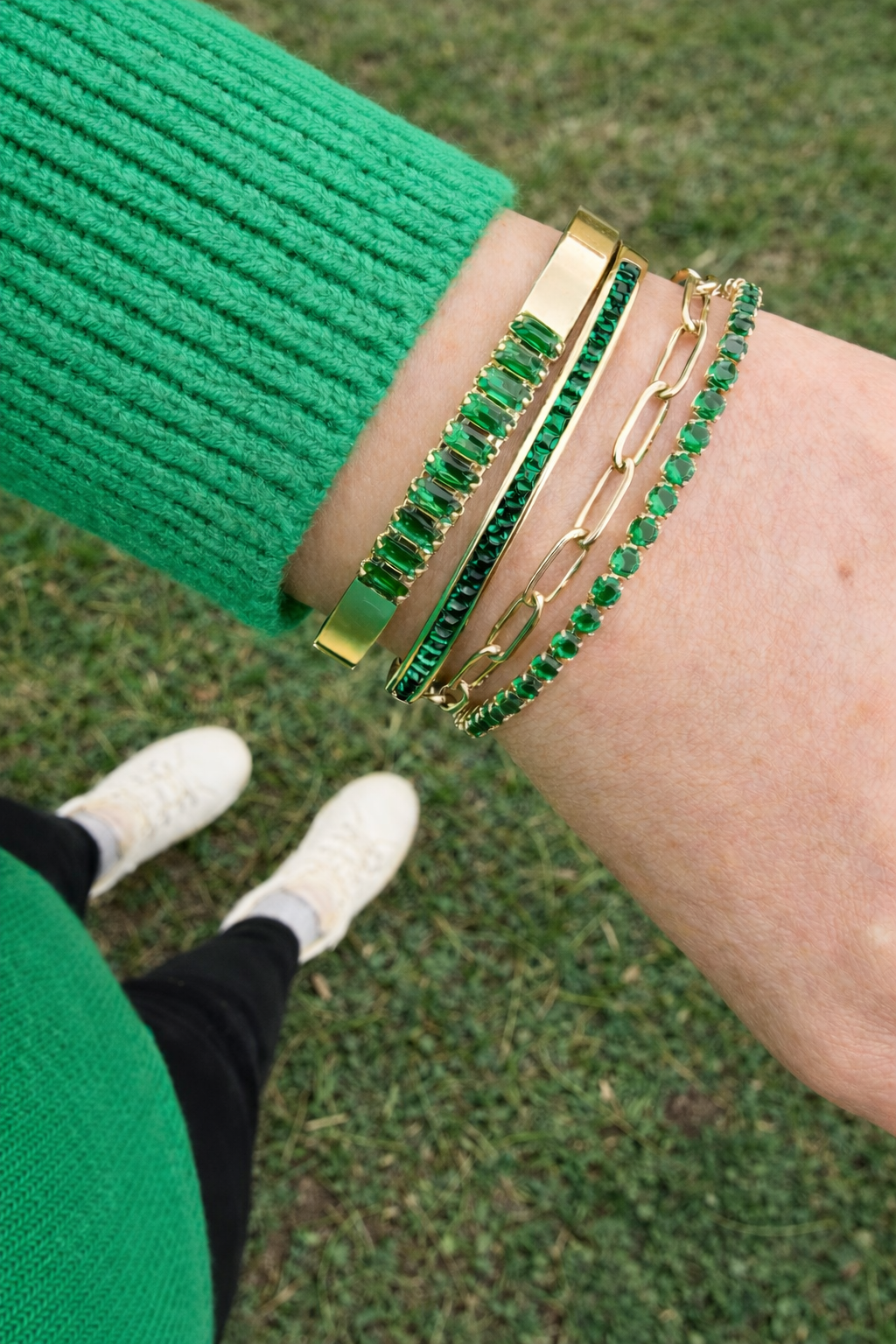 VEITA gold bracelet stack featuring emerald green crystal tennis bracelet, chain bracelet, and crystal bar bracelet
