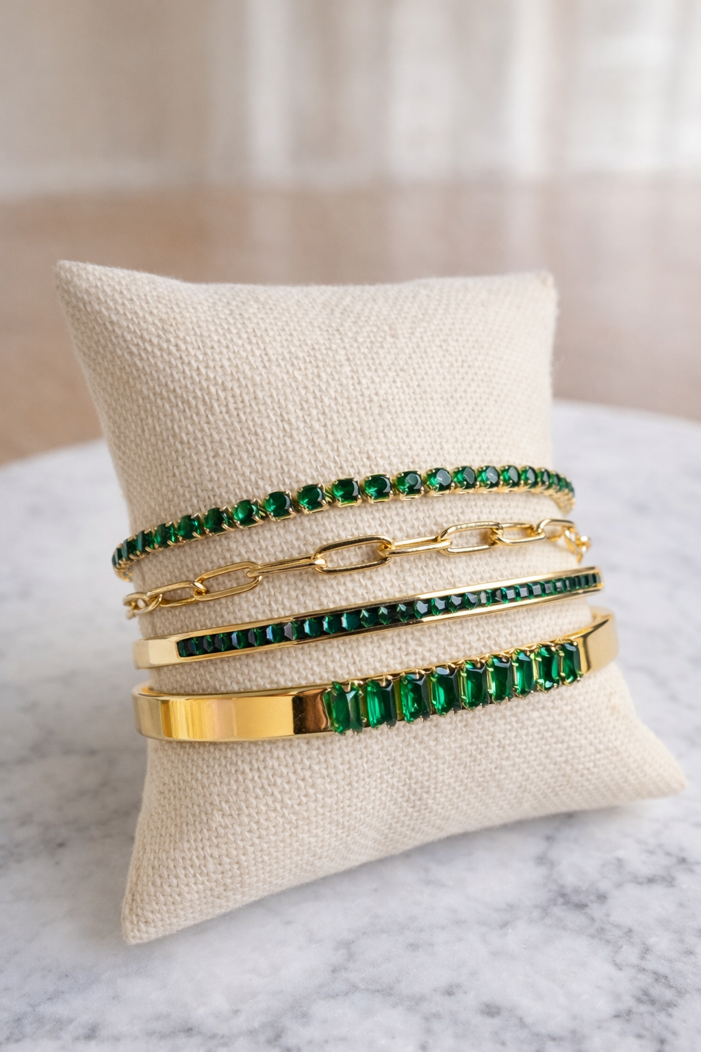VEITA green crystal bracelet stack styled with gold chain bracelet and emerald stones