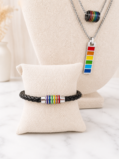 Harvey Barrel Necklace with Pride rainbow pendant styled necklace with a black leather Pride bracelet with rainbow barrel beads on linen jewelry displays