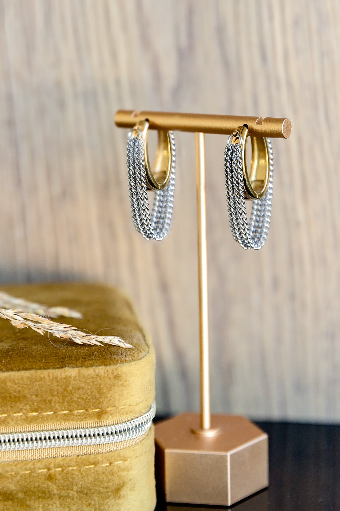 VEITA Jewelry gold hoop earrings with silver chain fringe displayed on gold earring stand next to mustard velvet jewelry box