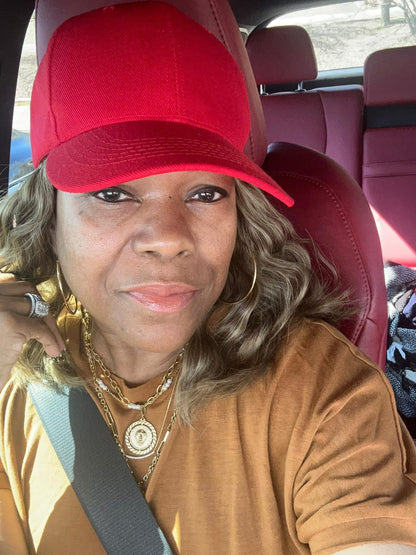 Model wearing VEITA Jewelry gold hoop earrings and layered gold necklaces with coin medallion pendant