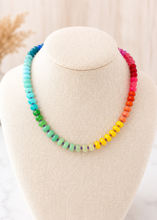 Rainbow Natural Stone Necklace with colorful beaded stones displayed on a linen jewelry bust