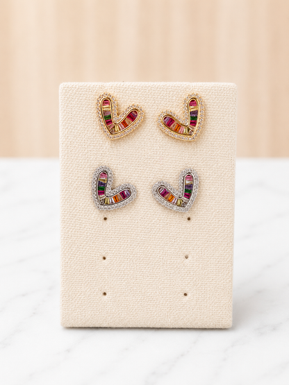 Simone Heart Studs in gold and silver with multicolor baguette gemstones on a linen earring display card