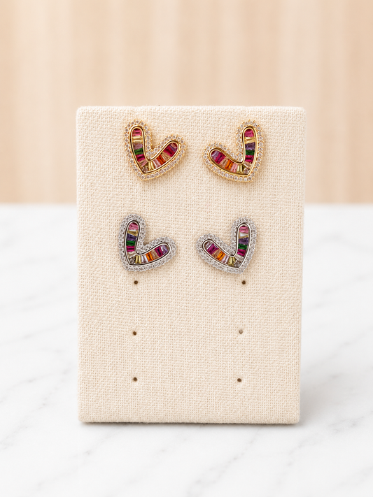Simone Heart Studs in gold and silver with multicolor baguette gemstones on a linen earring display card